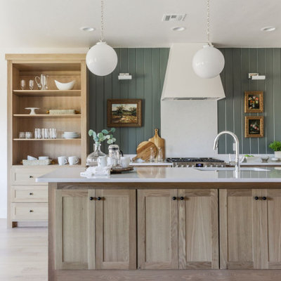 Mid-sized transitional l-shaped light wood floor and beige floor open concept kitchen photo in Oklahoma City with an undermount sink, shaker cabinets, light wood cabinets, quartz countertops, white backsplash, quartz backsplash, stainless steel appliances, an island and white countertops