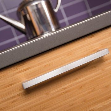 The Beauty of Bamboo: A Close Up of Bamboo Kitchen Cabinets and a Purple Backspl
