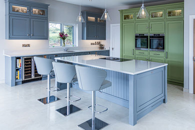 Inspiration for a traditional l-shaped kitchen in Other with a submerged sink, beaded cabinets, blue cabinets, stainless steel appliances, an island, white floors and white worktops.