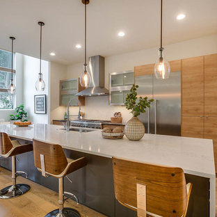 Contemporary eat-in kitchen designs - Example of a trendy light wood floor and beige floor eat-in kitchen design in Seattle with an undermount sink, flat-panel cabinets, light wood cabinets, stainless steel appliances and an island