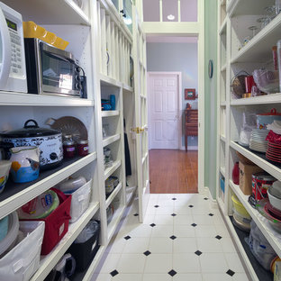 Design ideas for a mid-sized arts and crafts galley kitchen pantry in Los Angeles with shaker cabinets, white cabinets, granite benchtops, ceramic floors, no island, an undermount sink, black splashback, stone slab splashback, white appliances and white floor.