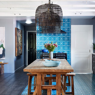 Eclectic l-shaped eat-in kitchen in Other with recessed-panel cabinets, black cabinets, white splashback, black appliances, with island, blue floor and white benchtop.