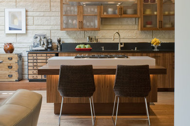 Example of a trendy open concept kitchen design in San Francisco with glass-front cabinets, medium tone wood cabinets, wood countertops and black backsplash