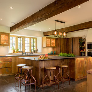 Large country l-shaped kitchen in Other with a double-bowl sink, an island, flat-panel cabinets, brown cabinets and grey floors.