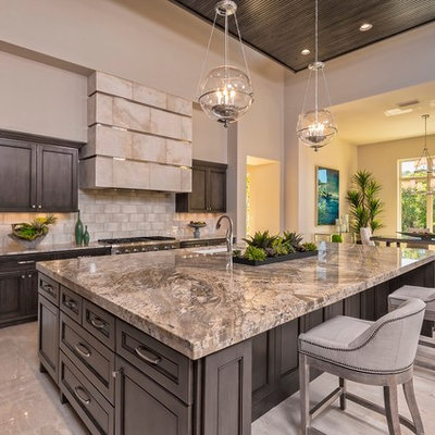 Open concept kitchen - large transitional marble floor and beige floor open concept kitchen idea in Austin with an undermount sink, dark wood cabinets, beige backsplash, stainless steel appliances, an island, granite countertops, subway tile backsplash and recessed-panel cabinets