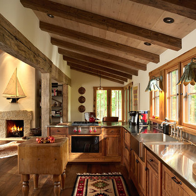 Open concept kitchen - rustic open concept kitchen idea in Minneapolis with an integrated sink, stainless steel countertops, shaker cabinets and stainless steel appliances