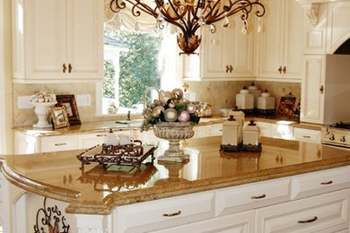 ワシントンD.C.にある高級な広いトラディショナルスタイルのおしゃれなキッチン (レイズドパネル扉のキャビネット、白いキャビネット、大理石カウンター、ベージュキッチンパネル、パネルと同色の調理設備、濃色無垢フローリング) の写真