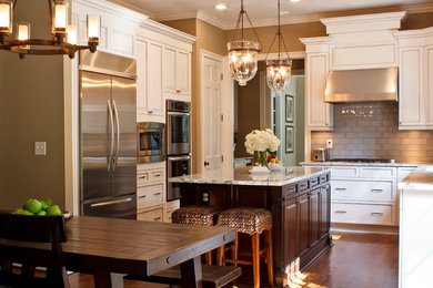Example of a classic l-shaped eat-in kitchen design in Atlanta with granite countertops, recessed-panel cabinets, white cabinets, multicolored backsplash, glass tile backsplash and stainless steel appliances