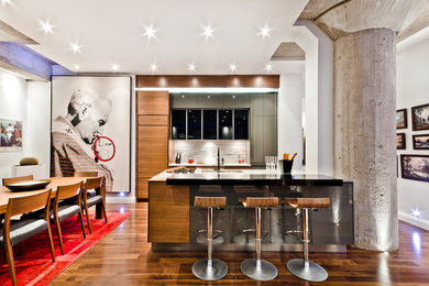 Trendy eat-in kitchen photo in Montreal with flat-panel cabinets and medium tone wood cabinets