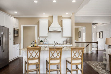 Eat-in kitchen - traditional eat-in kitchen idea in Louisville with recessed-panel cabinets, white cabinets, white backsplash, stainless steel appliances and an island