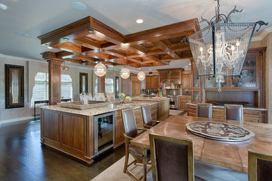 Kitchen - large traditional dark wood floor kitchen idea in New York with raised-panel cabinets, dark wood cabinets, granite countertops, ceramic backsplash, stainless steel appliances and two islands