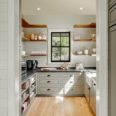 Cottage u-shaped light wood floor and beige floor kitchen pantry photo in San Francisco with no island, a farmhouse sink, shaker cabinets, gray cabinets and gray countertops