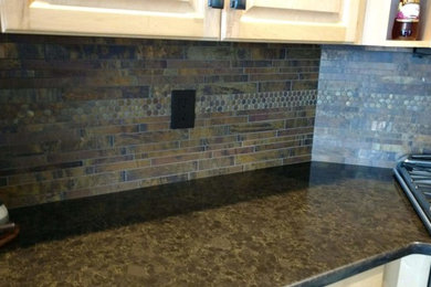 Kitchen - kitchen idea in Other with quartz countertops, metal backsplash and brown countertops