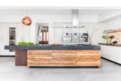 Photo of a contemporary single-wall kitchen in London with an island.