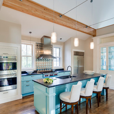 Mid-sized trendy galley dark wood floor open concept kitchen photo in Portland Maine with an island, shaker cabinets, metallic backsplash, stainless steel appliances, an undermount sink, turquoise cabinets, laminate countertops and metal backsplash