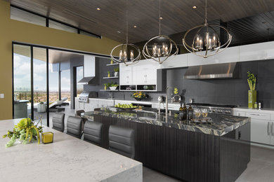 Open concept kitchen - large contemporary l-shaped gray floor open concept kitchen idea in Las Vegas with a drop-in sink, flat-panel cabinets, white cabinets, quartz countertops, black backsplash, stainless steel appliances, two islands and multicolored countertops