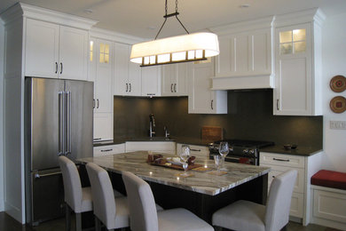 Arts and crafts l-shaped open concept kitchen photo in Toronto with shaker cabinets, white cabinets, quartz countertops, stone slab backsplash and an island
