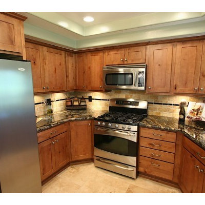 Example of a small transitional u-shaped travertine floor eat-in kitchen design in Other with an undermount sink, shaker cabinets, medium tone wood cabinets, granite countertops, beige backsplash, stone tile backsplash, stainless steel appliances and no island