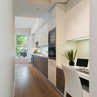 Small contemporary open concept kitchen inspiration - Example of a small trendy single-wall medium tone wood floor open concept kitchen design in DC Metro with flat-panel cabinets, white cabinets, no island, an undermount sink, quartz countertops, white backsplash, glass tile backsplash and stainless steel appliances