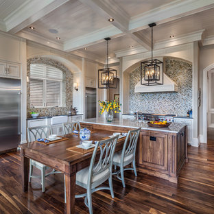 Traditional eat-in kitchen appliance - Example of a classic dark wood floor eat-in kitchen design in Other with white cabinets, granite countertops, multicolored backsplash, mosaic tile backsplash, stainless steel appliances, an island and beaded inset cabinets