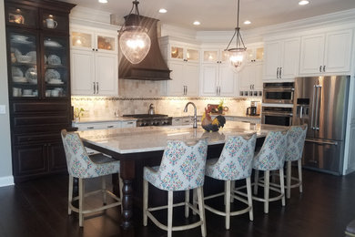 Inspiration for a large timeless l-shaped kitchen remodel in Cincinnati with raised-panel cabinets, granite countertops, stainless steel appliances and an island