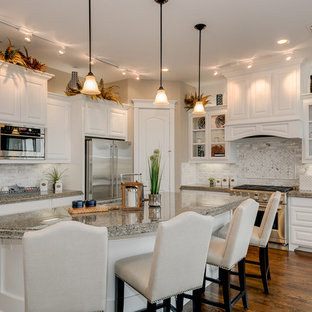 Traditional open concept kitchen ideas - Inspiration for a timeless l-shaped dark wood floor open concept kitchen remodel in Dallas with a double-bowl sink, raised-panel cabinets, white cabinets, granite countertops, beige backsplash, porcelain backsplash, stainless steel appliances and an island