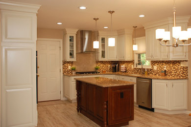 Mid-sized transitional l-shaped vinyl floor eat-in kitchen photo in Philadelphia with an undermount sink, raised-panel cabinets, white cabinets, granite countertops, multicolored backsplash, mosaic tile backsplash, stainless steel appliances and an island