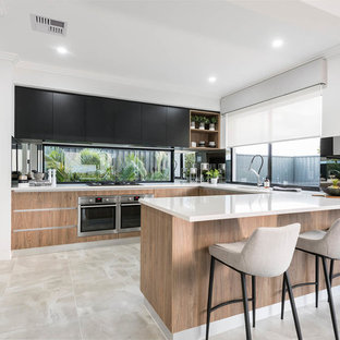 Design ideas for a large contemporary u-shaped kitchen in Perth with an undermount sink, flat-panel cabinets, black cabinets, quartz benchtops, stainless steel appliances, porcelain floors, a peninsula, beige floor and window splashback.