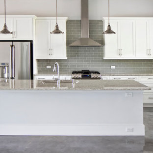 Mid-sized modern eat-in kitchen designs - Inspiration for a mid-sized modern l-shaped concrete floor eat-in kitchen remodel in Jacksonville with an undermount sink, shaker cabinets, white cabinets, granite countertops, gray backsplash, subway tile backsplash, stainless steel appliances and an island
