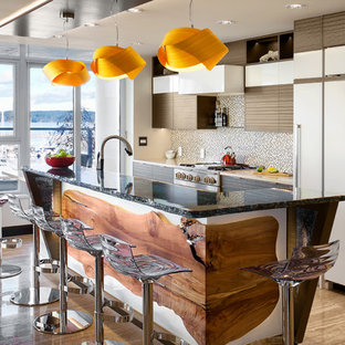 Mid-sized contemporary galley eat-in kitchen in Vancouver with an undermount sink, flat-panel cabinets, white cabinets, recycled glass benchtops, beige splashback, glass sheet splashback, panelled appliances, marble floors, with island and brown floor.