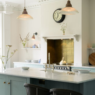 Traditional kitchen appliance - Inspiration for a timeless galley kitchen remodel in Other with a farmhouse sink, shaker cabinets, blue cabinets, marble countertops and an island