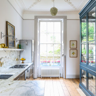 Photo of a medium sized classic l-shaped kitchen/diner in Other with a submerged sink, flat-panel cabinets, stainless steel cabinets, marble worktops, multi-coloured splashback, marble splashback, stainless steel appliances, light hardwood flooring, no island and beige floors.