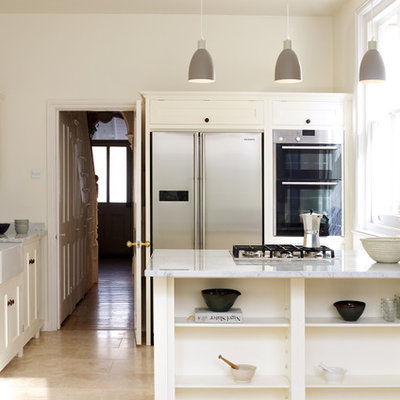 Example of a trendy kitchen design in London with a peninsula