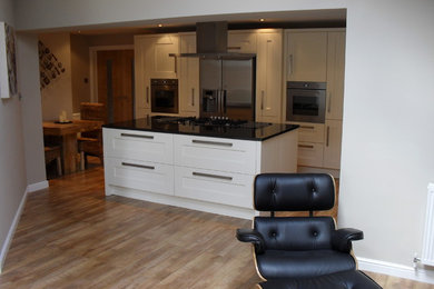 Photo of a modern kitchen/diner in Other with a submerged sink, shaker cabinets, granite worktops, stainless steel appliances and an island.