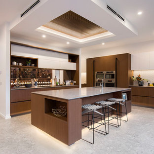Design ideas for a contemporary kitchen in Melbourne with a single-bowl sink, flat-panel cabinets, dark wood cabinets, white splashback, stainless steel appliances, with island, grey floor and grey benchtop.