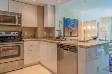 Eat-in kitchen - mid-sized contemporary l-shaped marble floor eat-in kitchen idea in Miami with an undermount sink, flat-panel cabinets, white cabinets, granite countertops and stainless steel appliances