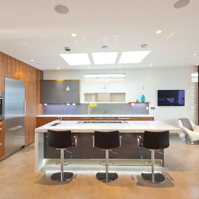 Example of a minimalist kitchen design in Vancouver with stainless steel appliances