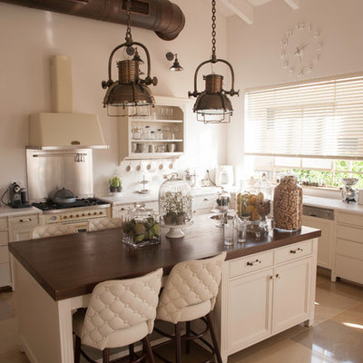 Inspiration for a transitional kitchen remodel in Tel Aviv with recessed-panel cabinets, beige cabinets, wood countertops, an island and white appliances