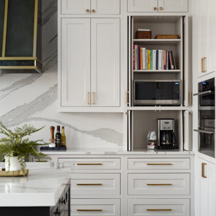 Photo of a large transitional l-shaped open plan kitchen in Chicago with an undermount sink, flat-panel cabinets, white cabinets, quartz benchtops, white splashback, engineered quartz splashback, panelled appliances, dark hardwood floors, multiple islands, brown floor, white benchtop and coffered.
