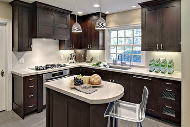 Inspiration for a mid-sized contemporary l-shaped eat-in kitchen remodel in Minneapolis with dark wood cabinets, recessed-panel cabinets, white backsplash and paneled appliances