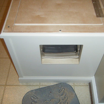 This opening is access to the cat's litter box. The lid lifts up for easy cleani