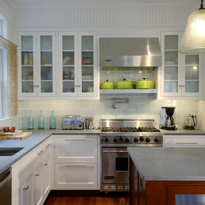 Inspiration for a transitional kitchen remodel in Boston with glass-front cabinets, stainless steel appliances and subway tile backsplash