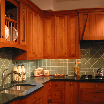 Tile back splash compliments a custom cherry kitchen by Country Side Cabinetry