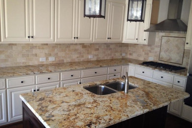 Large kitchen in Charlotte with a double-bowl sink, recessed-panel cabinets, white cabinets, granite worktops and an island.