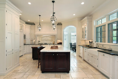 Large transitional travertine floor eat-in kitchen photo in Detroit with white backsplash, an island, a farmhouse sink, beaded inset cabinets, white cabinets, marble countertops, subway tile backsplash and paneled appliances