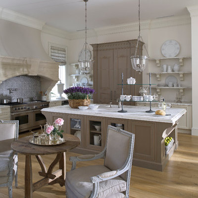 Eat-in kitchen - huge traditional l-shaped light wood floor eat-in kitchen idea in Miami with stainless steel appliances, an undermount sink, recessed-panel cabinets, marble countertops, an island, beige cabinets and gray backsplash