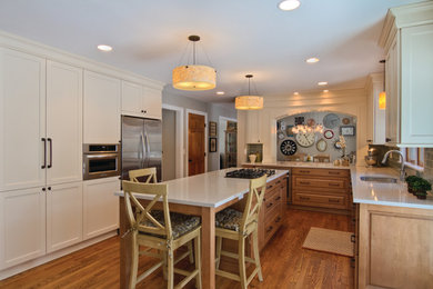 Kitchen - mid-sized eclectic u-shaped medium tone wood floor kitchen idea in Detroit with an undermount sink, flat-panel cabinets, light wood cabinets, quartz countertops, blue backsplash, glass tile backsplash, stainless steel appliances and an island