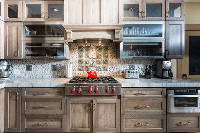 Large transitional l-shaped medium tone wood floor eat-in kitchen photo in Other with an undermount sink, shaker cabinets, dark wood cabinets, marble countertops, multicolored backsplash, mosaic tile backsplash, stainless steel appliances and an island