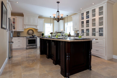 Large elegant u-shaped eat-in kitchen photo in Other with raised-panel cabinets, white cabinets, granite countertops, stainless steel appliances and an island