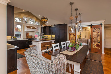 Example of a large eclectic medium tone wood floor kitchen design in Detroit with a farmhouse sink, recessed-panel cabinets, wood countertops and an island